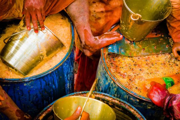 Drums and drums of colored water being prepared and moved