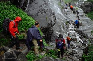 Hampta Pass Trek- passing under a waterfall